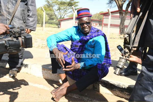 FDC President candidate @PatrickAmuriat gets off the ground where he'd been seated protesting against police blocking his Moroto-rally, walks barefoot & starts addressing children, all as security forces maintain a blockade