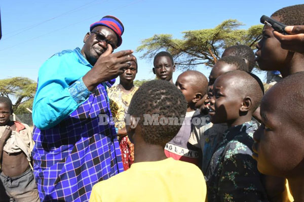 FDC President candidate @PatrickAmuriat gets off the ground where he'd been seated protesting against police blocking his Moroto-rally, walks barefoot & starts addressing children, all as security forces maintain a blockade